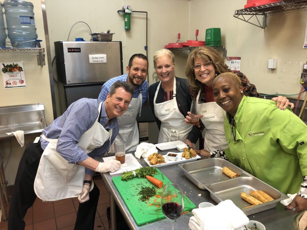 Having fun in the kitchen during one of our Atlanta cooking classes.